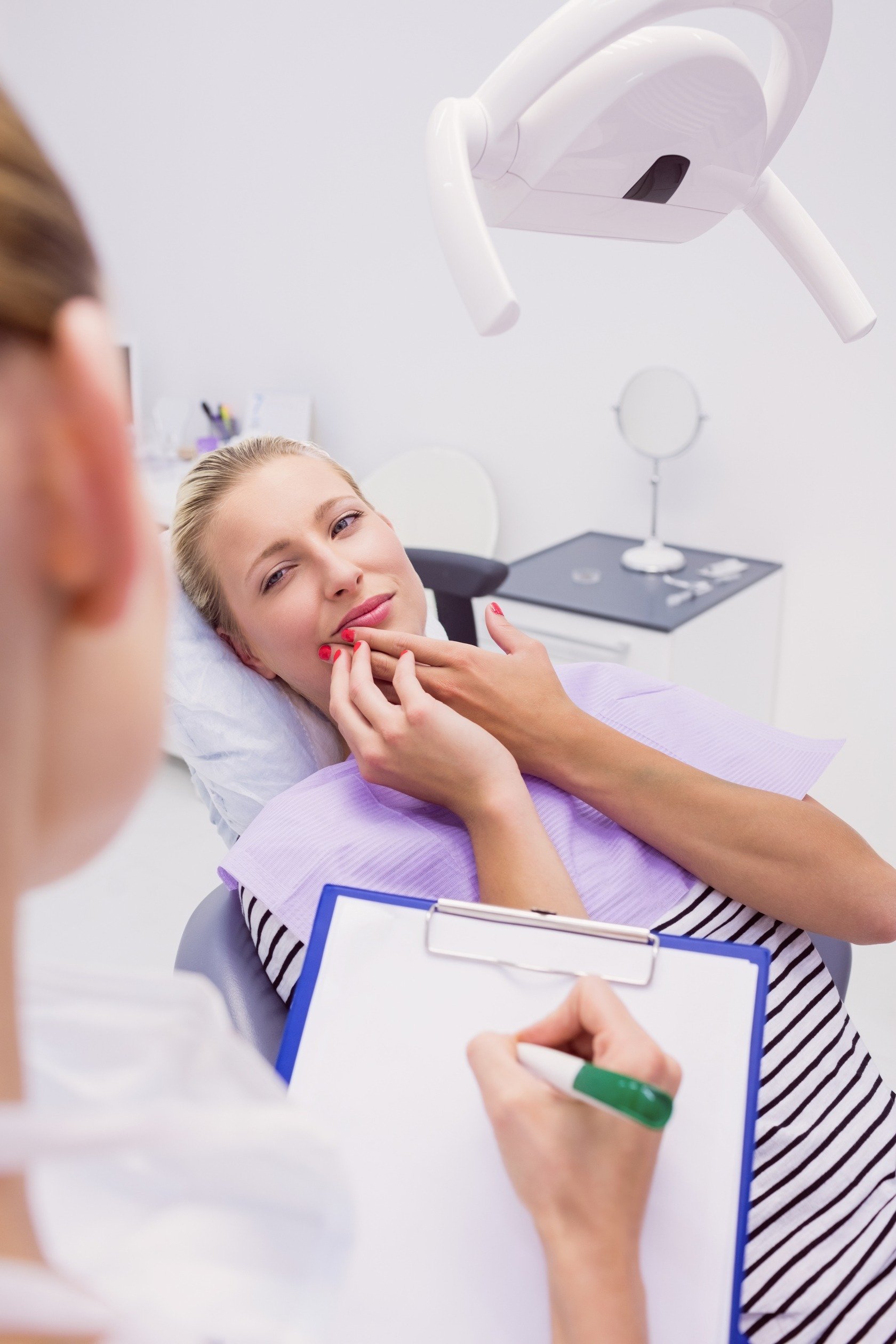 women with toothache at dental exam
